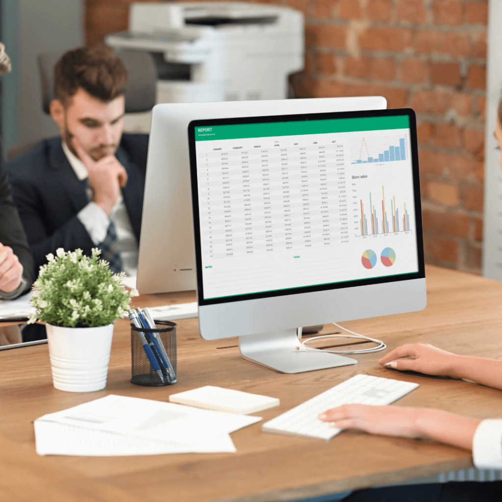 A person calculating finances on a computer desktop